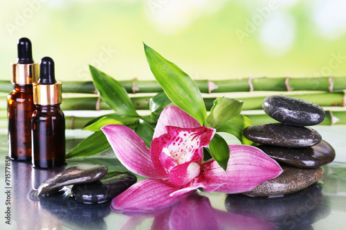 Naklejka samoprzylepna Kamienie spa, orchidea, gałęzie bambusa i olej aromatyczny