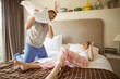 © WavebreakMediaMicro - Cute couple having a pillow fight