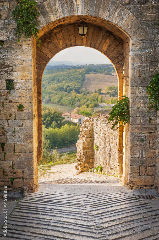 Exit the town of Monteriggioni with views of the Tuscan landscap - obrazy, fototapety, plakaty 