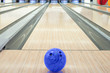 Balls on bowling alley against ten pins