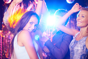 Poster - Energetic young people dancing in night club