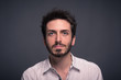 © pio3 - Man close up portrait against dark background.