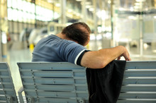 Man Sleeping On A Bench In The Station