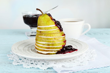 Wall Mural - Tasty dessert with sliced pear, cream and berry sauce