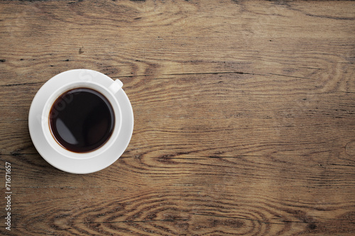 Fényképezés  Black coffee cup on old wooden table top view