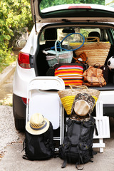 Wall Mural - Suitcases and bags in trunk of car ready to depart for holidays