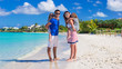 © travnikovstudio - Young family with two kids at tropical white beach