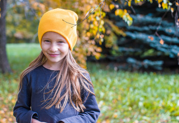 Adorable little girl at beautiful autumn day outdoors