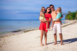 © travnikovstudio - Family of four on beach vacation
