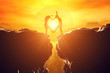 © Photocreo Bednarek - Happy couple in love making heart shape over precipice