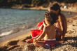 © BalanceFormCreative - Two little sisters playing with sand  on the beach