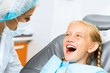 © adam121 - Dentist inspecting patient