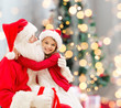 © Syda Productions - smiling little girl with santa claus