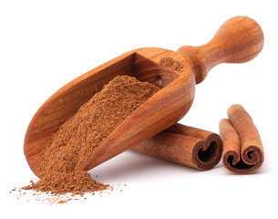 ground cinnamon spice powder in wooden spoon isolated on white b