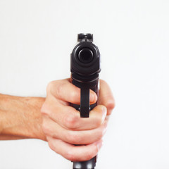 Hand with gun pointing forward close up