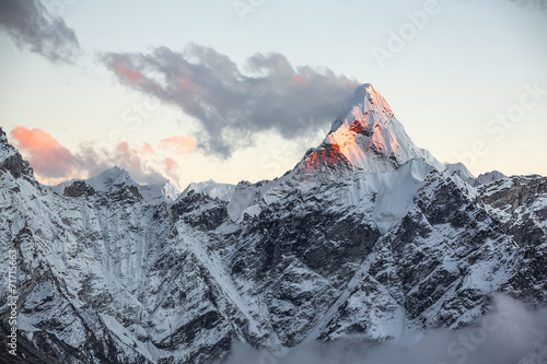 First rays of the rising sun on the top of Ama Dablam peak Poster