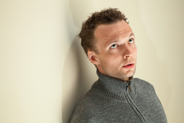 Wall Mural - Closeup portrait of young thinking Caucasian man