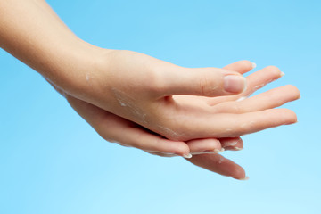 Wall Mural - Woman's hands in moisturizer cream