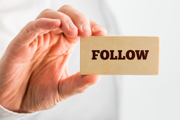 Wall Mural - hand holding small piece wood with follow text