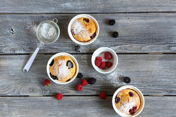 Wall Mural - cupcakes with summer berries, top view