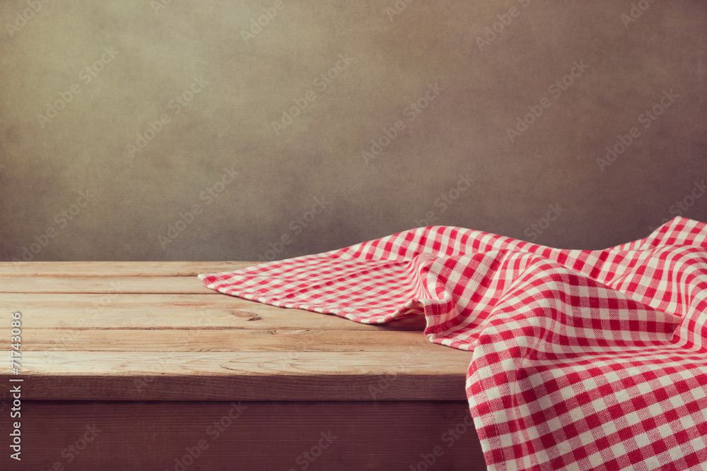 Empty wooden deck table with checked tablecloth - obrazy, fototapety, plakaty 