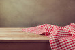 Empty wooden deck table with checked tablecloth