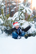 © frolova_elena - Happy boy in a cap of Santa Claus in the winter forest.