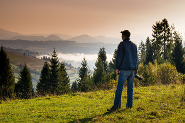 Wall Mural - Man photographer in the mountains.