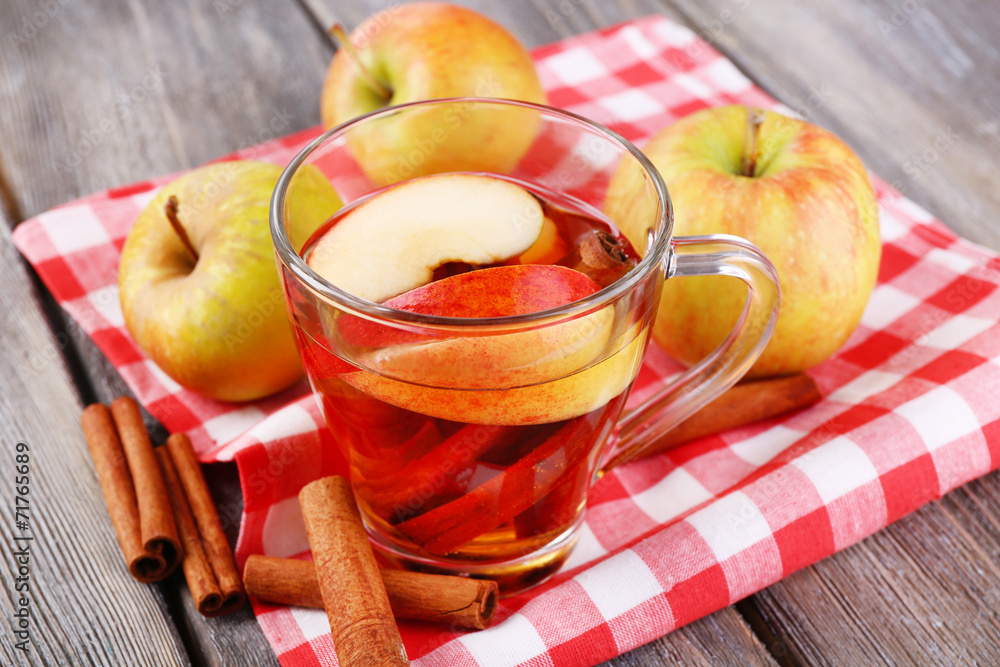 Apple cider with cinnamon sticks and fresh apples