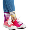 © Africa Studio - Female legs in colorful socks and sneakers isolated on white