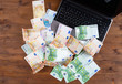 © pavel_812 - Pile of euro money with Laptop on the table