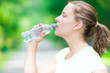 © mr.markin - Woman drinking cold mineral water from a bottle after fitness ex