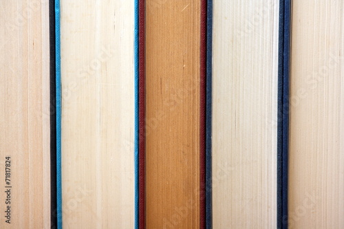 Valokuva Old hardback books in a row form a background image