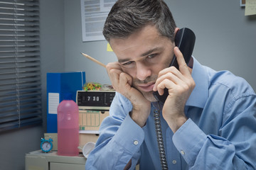 Wall Mural - Tired businessman on the phone