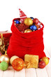 Red bag with Christmas toys on bright background