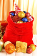 Red bag with Christmas toys on fabric background
