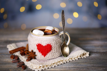 Poster - Cup of tasty hot cocoa, on wooden table, on shiny background