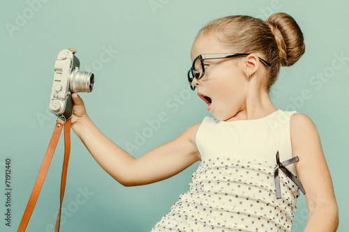 Fototapeta child holding a instant camera