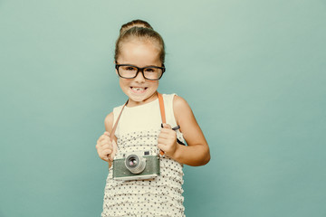 Wall Mural - child holding a instant camera