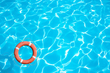 Lifebuoy On Blue Water Surface Concept