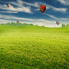 Summer field with lot of air balloons over horizon, abstract lan