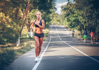 young woman jogging in the park in summer