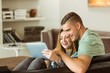 © WavebreakMediaMicro - Cute couple relaxing on couch with tablet pc