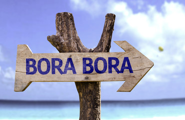 Wall Mural - Bora Bora wooden sign with a beach on background