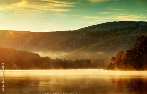 Beautiful autumn landscape, the lake in the morning fog