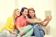 © Syda Productions - three smiling teenage girls with tablet pc at home