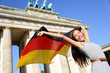 © Maridav - German flag woman happy at Berlin Brandenburg Gate