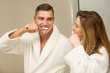 © WavebreakMediaMicro - Cute couple brushing their teeth