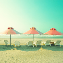 Sticker - Vintage pink umbrellas in summer beach