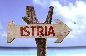 istria wooden sign with a beach on background